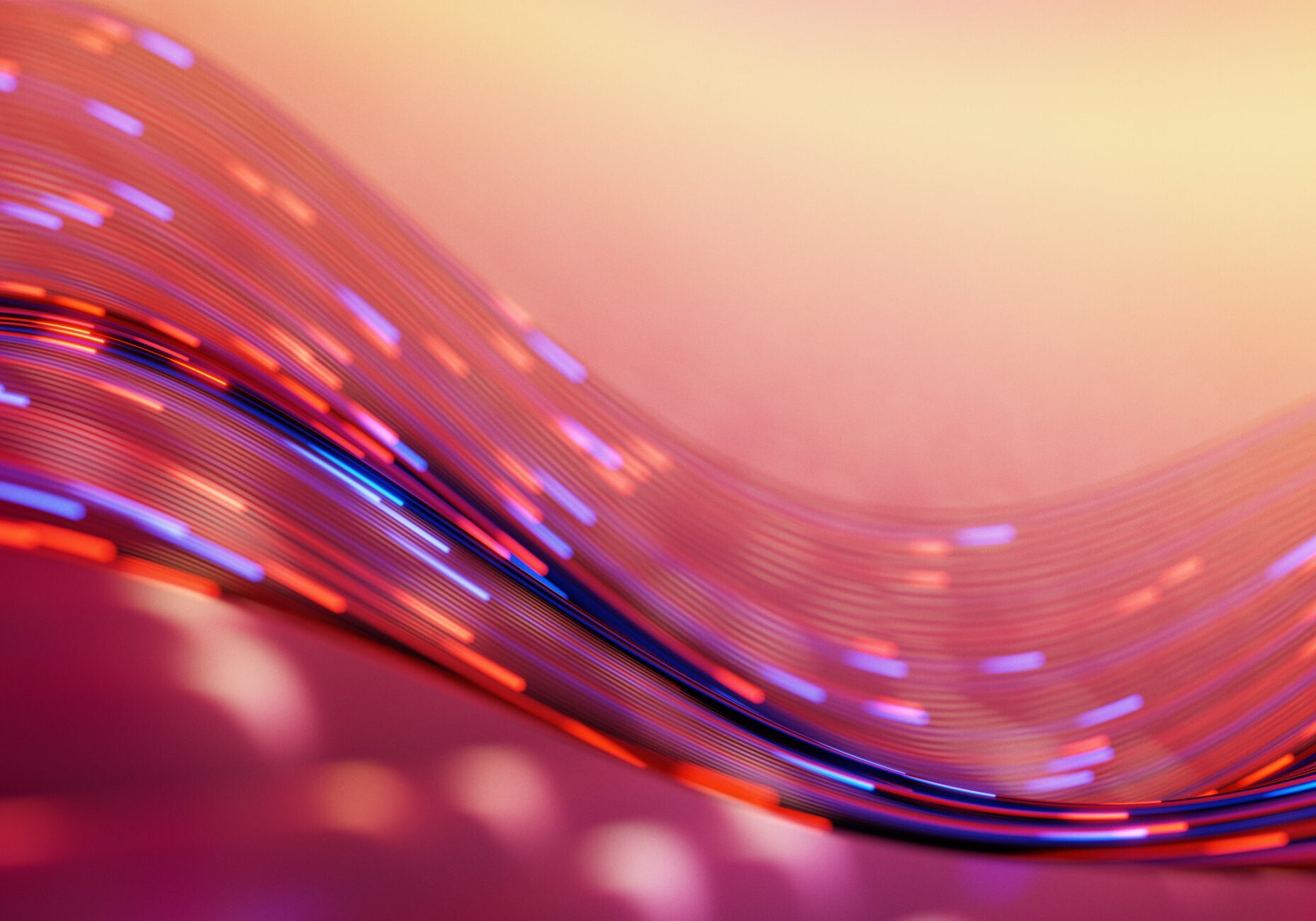 Colorful abstract wave of neon light trails and motion blur forming flowing lines over a warm gradient background, conveying movement, energy, and futuristic digital aesthetics for design and web use.